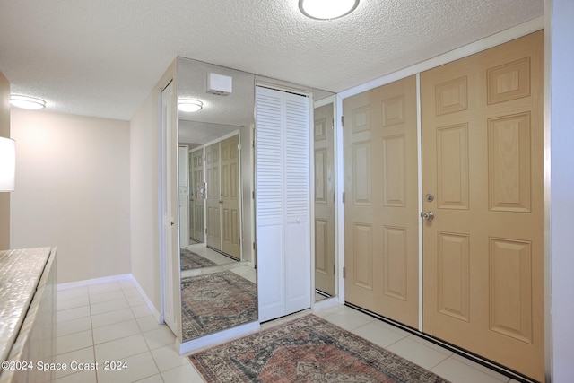 interior space featuring a textured ceiling and tile patterned floors