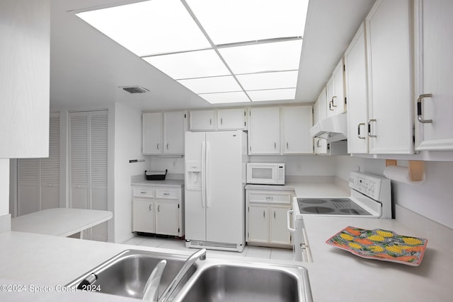 kitchen with white appliances and white cabinetry