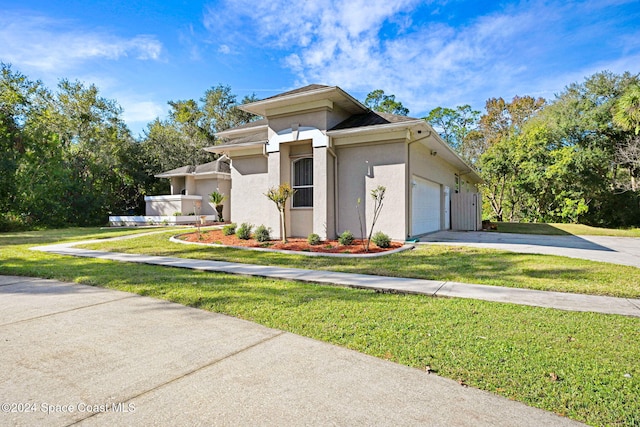 view of front of house with a garage and a front lawn