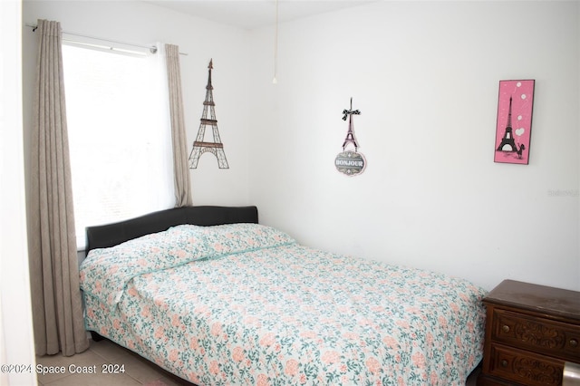 tiled bedroom with multiple windows