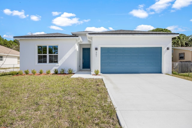 view of front of house featuring a garage and a front lawn