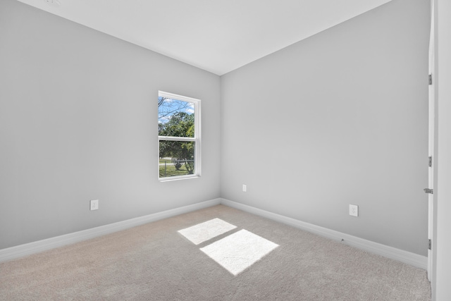 unfurnished room featuring light carpet