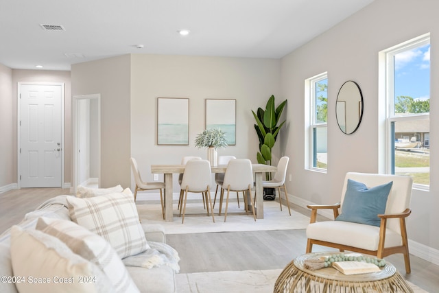 living room with plenty of natural light and light hardwood / wood-style floors