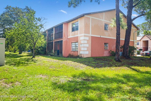 view of side of property featuring a yard