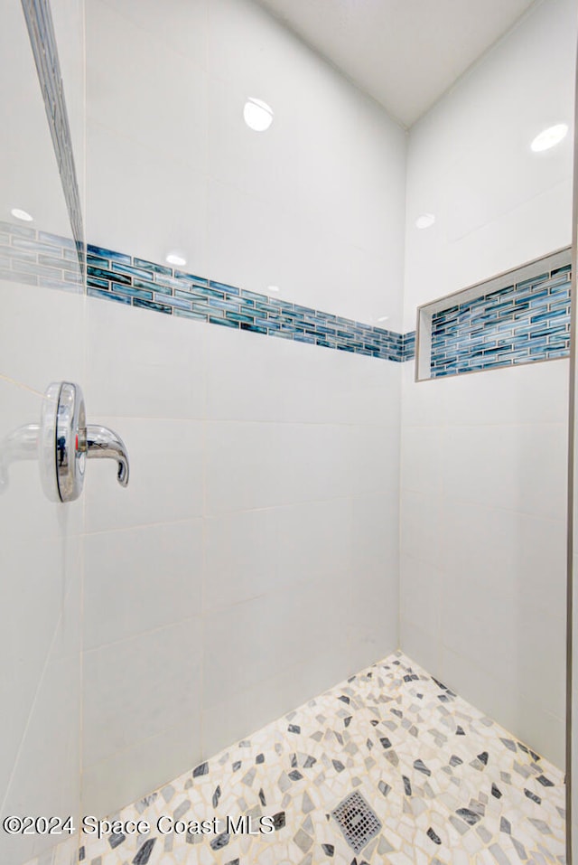 bathroom with a tile shower