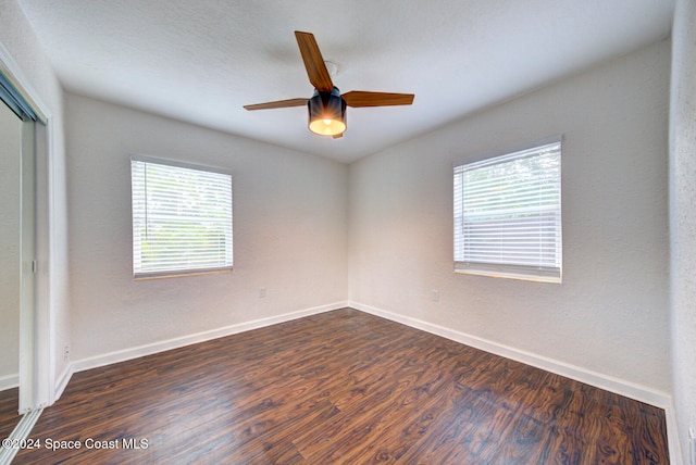 empty room featuring ceiling fan and dark hardwood / wood-style flooring