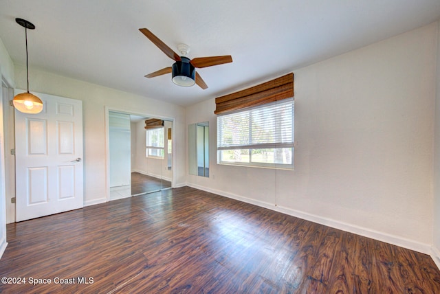 unfurnished room with ceiling fan and dark hardwood / wood-style floors