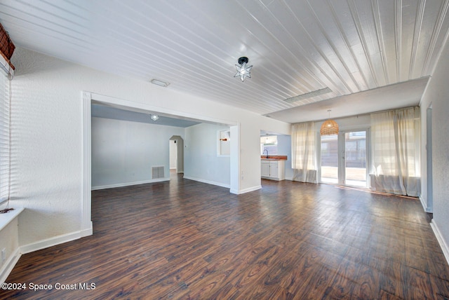 unfurnished living room featuring dark hardwood / wood-style floors