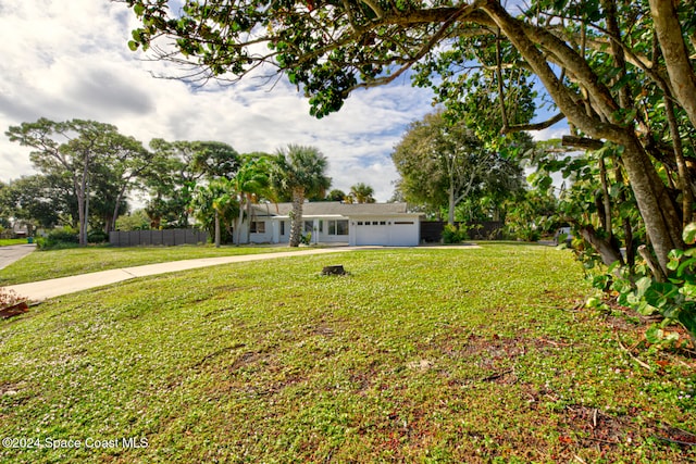 view of front of home featuring a garage and a front lawn