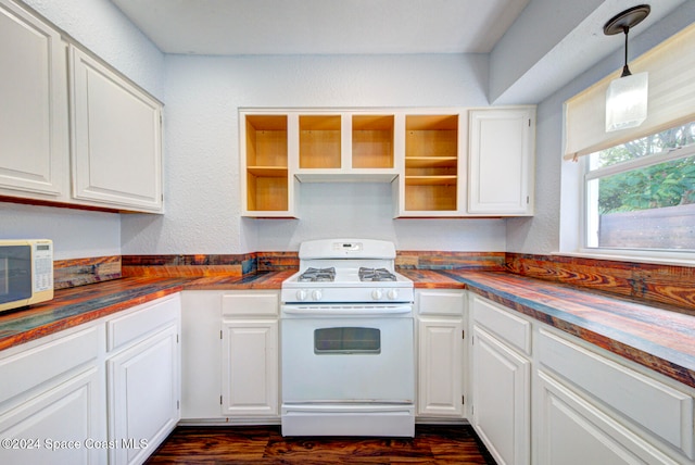 kitchen with white cabinets, white appliances, hanging light fixtures, and dark wood-type flooring