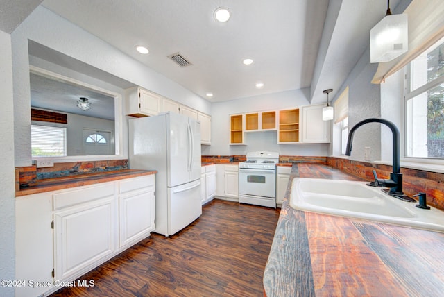 kitchen with sink, decorative light fixtures, white appliances, a wealth of natural light, and white cabinets