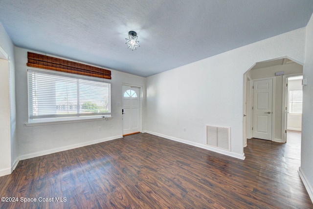 interior space featuring dark hardwood / wood-style floors and a textured ceiling