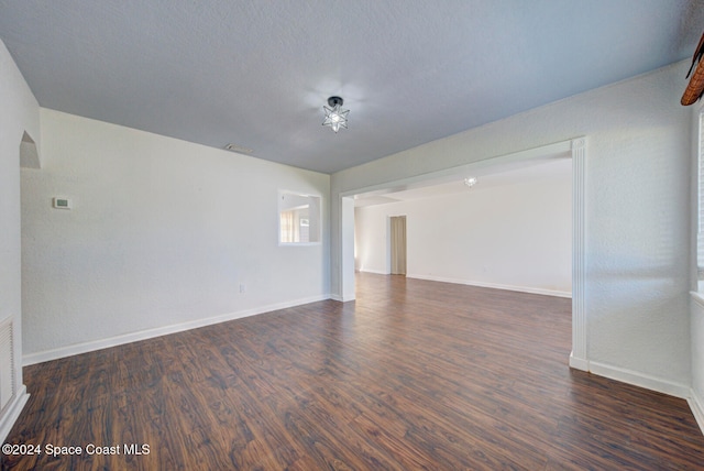 unfurnished room with dark hardwood / wood-style floors