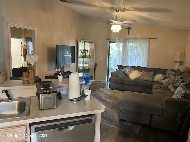 living room with ceiling fan, lofted ceiling, sink, a textured ceiling, and dark wood-type flooring