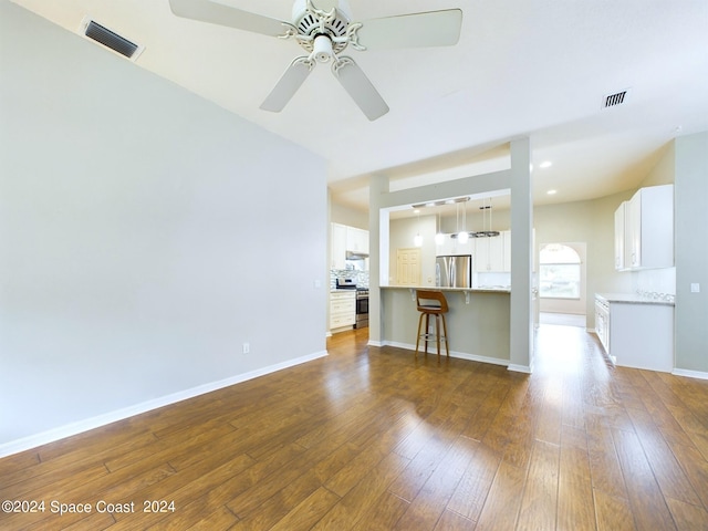 unfurnished living room with dark wood-type flooring and ceiling fan