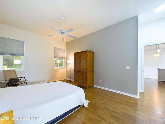 bedroom with multiple windows, hardwood / wood-style floors, and ceiling fan