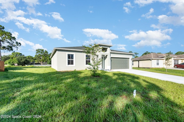 view of front of home featuring a garage and a front lawn