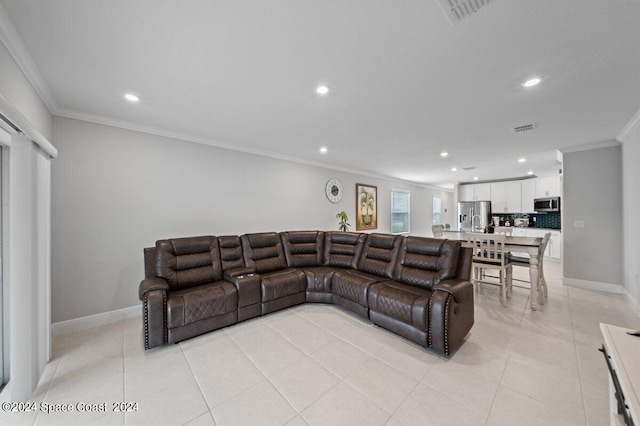 living room with light tile patterned floors and crown molding