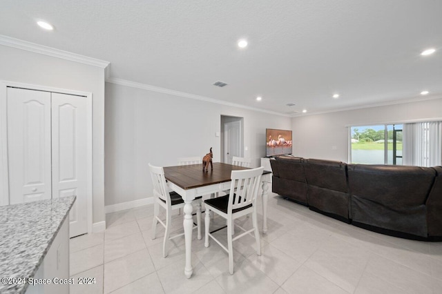 tiled dining area featuring ornamental molding