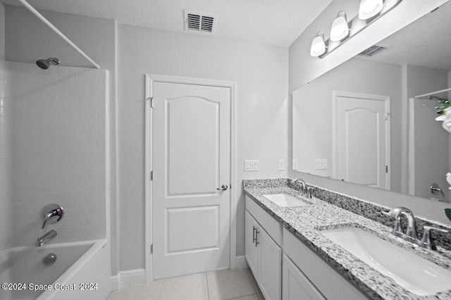 bathroom with shower / bathing tub combination, vanity, a textured ceiling, and tile patterned flooring