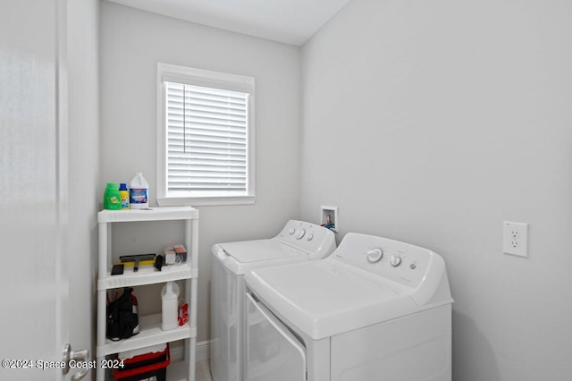 clothes washing area with washing machine and dryer