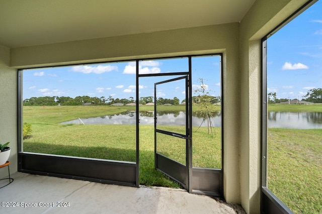 unfurnished sunroom with a water view