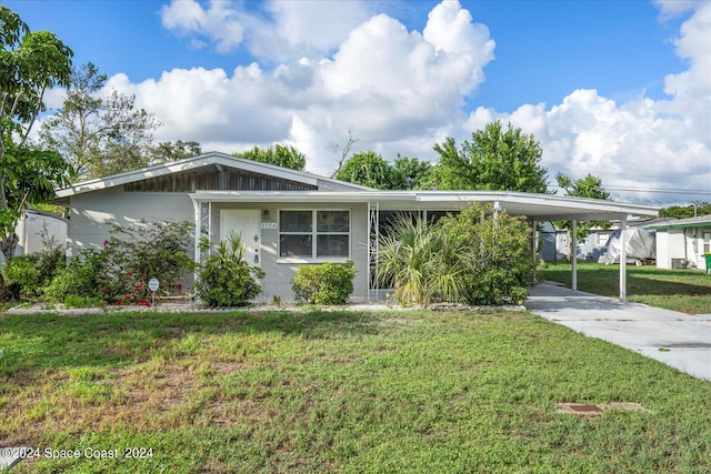 single story home with a front yard and a carport