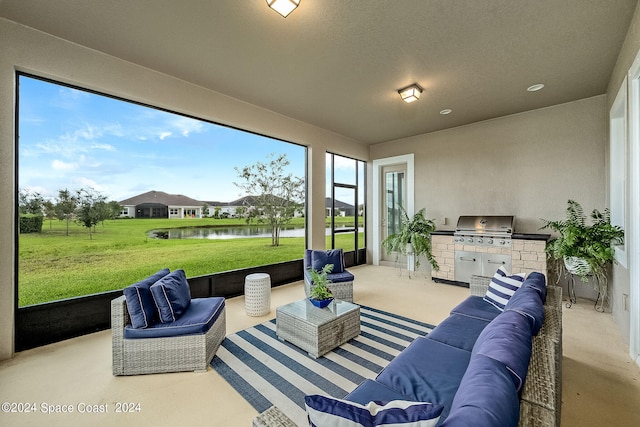 sunroom / solarium featuring a water view