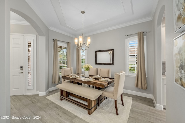 dining space featuring light hardwood / wood-style floors, ornamental molding, and a wealth of natural light