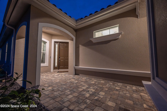 property entrance with a patio area