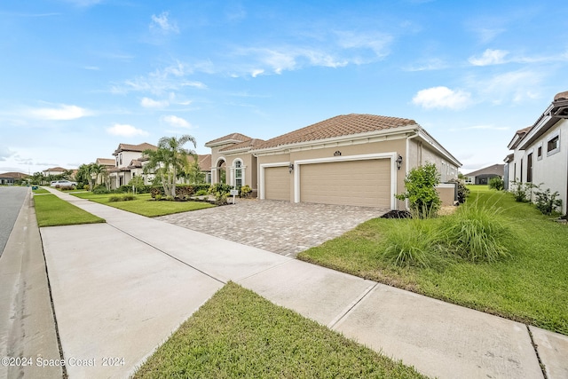 mediterranean / spanish-style house with a front lawn and a garage