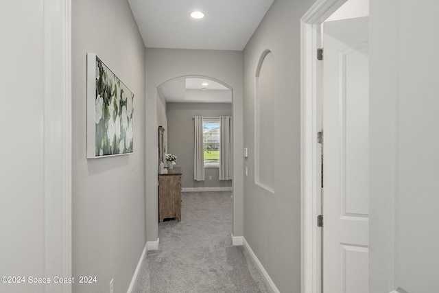 hallway with light colored carpet