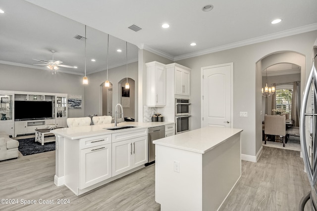 kitchen with a center island, decorative light fixtures, sink, and white cabinets