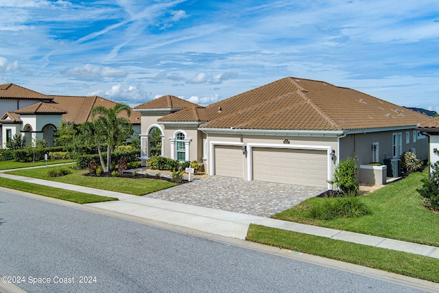 view of front of property with a front lawn and a garage