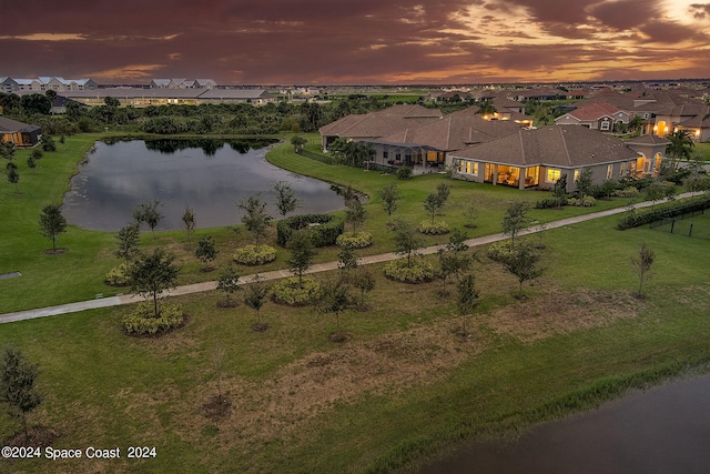 aerial view at dusk with a water view