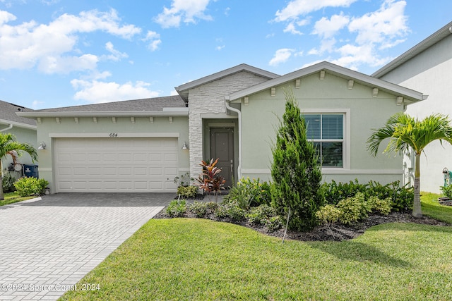 view of front of house with a garage and a front yard