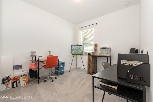 carpeted home office featuring lofted ceiling