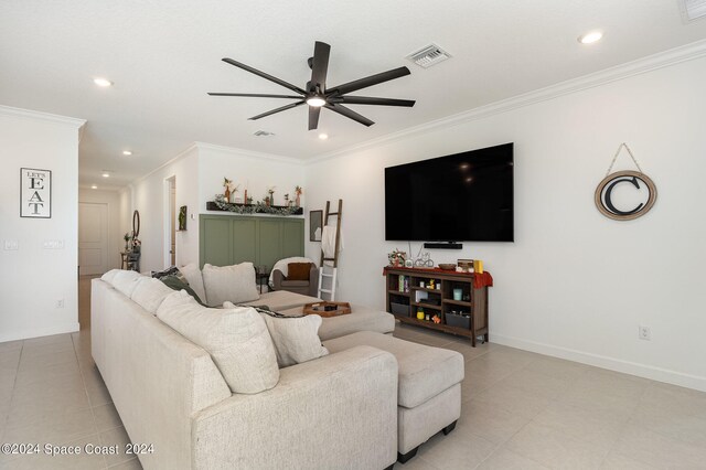 tiled living room with ceiling fan and crown molding