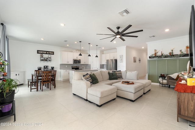 living room with ceiling fan, light tile patterned floors, and ornamental molding