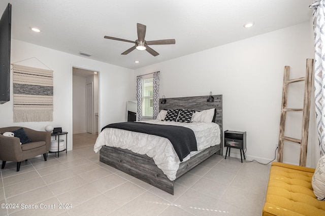 bedroom with ceiling fan and light tile patterned floors