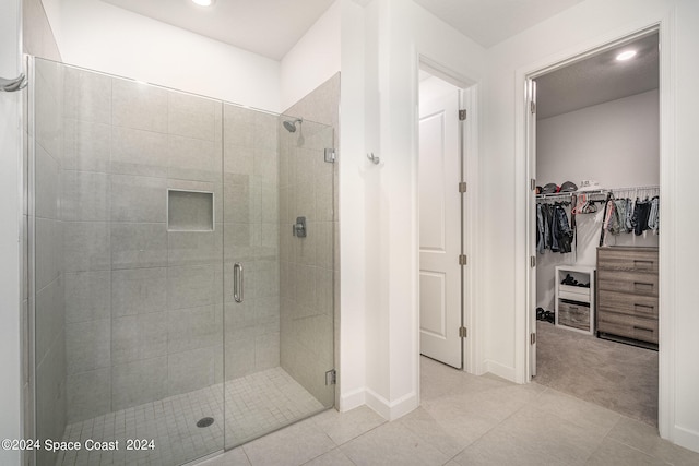 bathroom with walk in shower and tile patterned floors