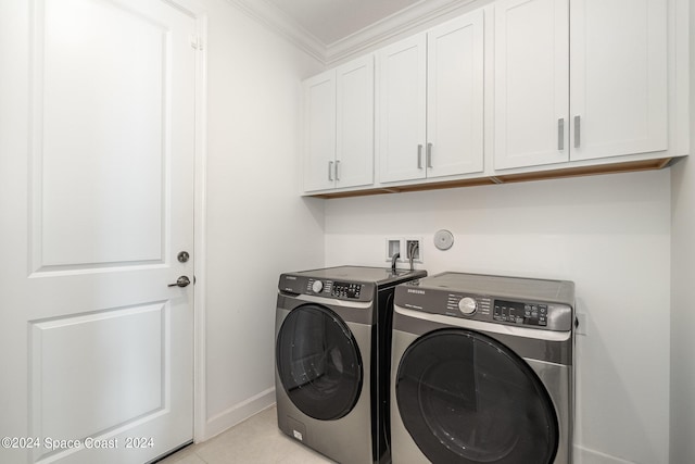 washroom featuring light tile patterned floors, washer and dryer, crown molding, and cabinets