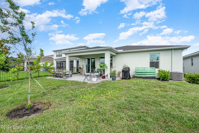 back of house featuring a patio area and a yard