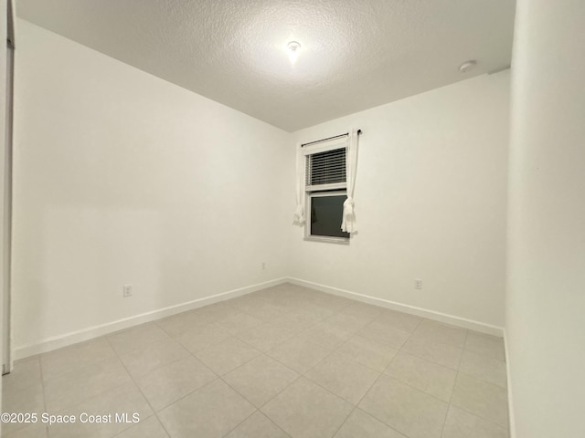 spare room with a textured ceiling