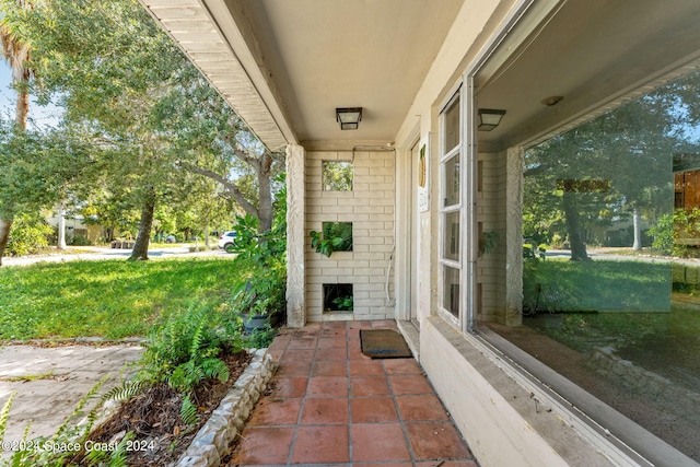 view of exterior entry with a lawn