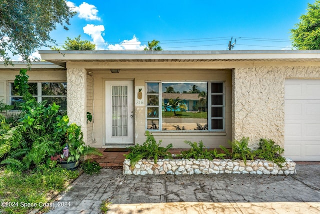 doorway to property featuring a garage