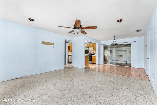 unfurnished living room with ceiling fan