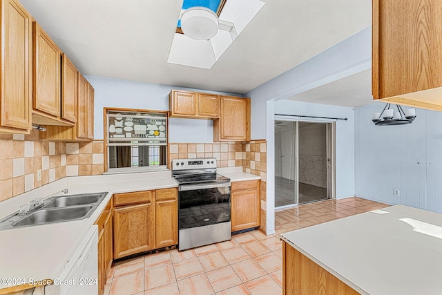 kitchen featuring tasteful backsplash, stainless steel range with electric stovetop, dishwasher, a skylight, and sink