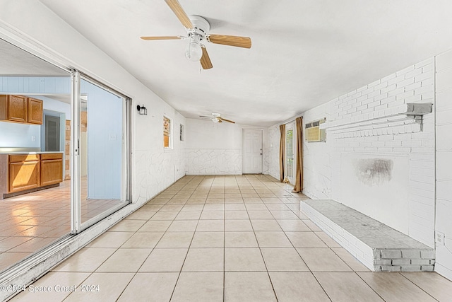 interior space with ceiling fan, light tile patterned floors, and a wall mounted AC