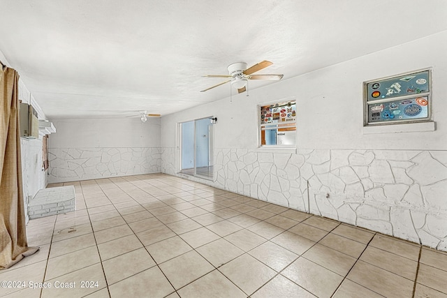 spare room featuring light tile patterned floors and ceiling fan